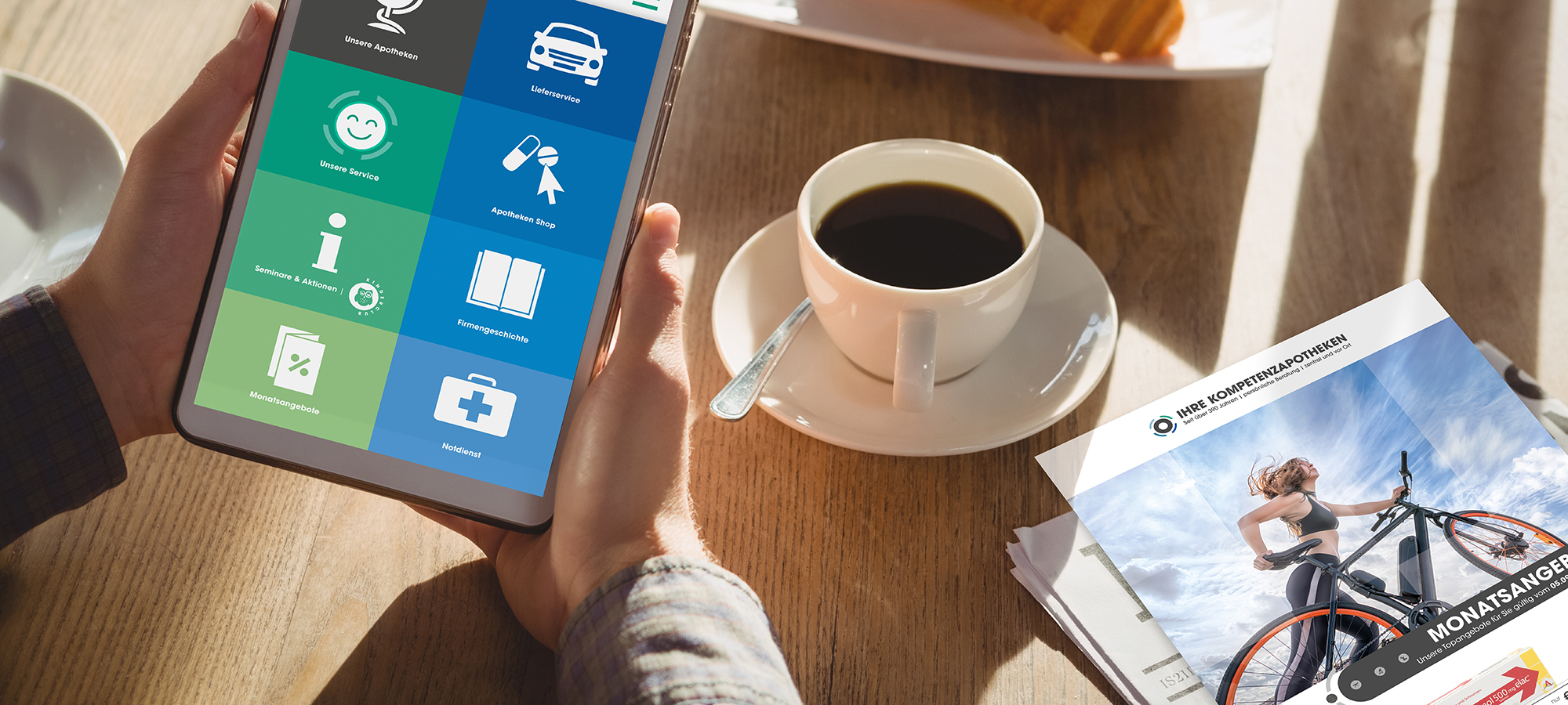 Cropped hands of businessman with breakfast using tablet in cafe